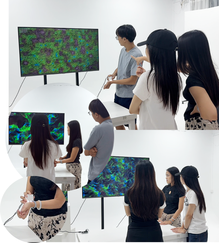 Participants discussing SOMA CHROMA around the display