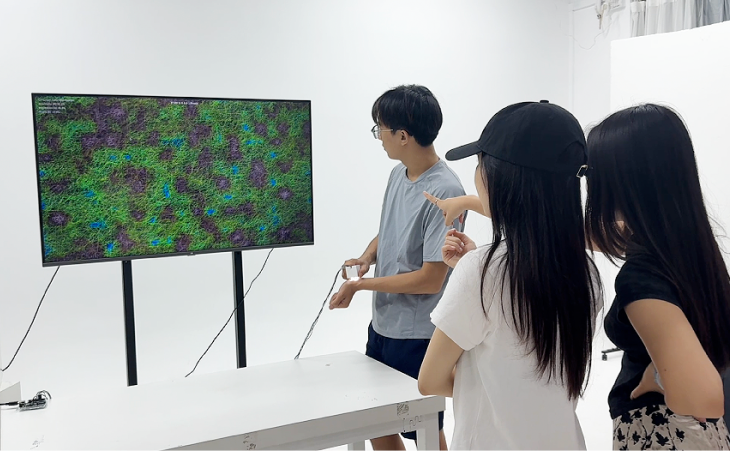 Three participants observing a translated SOMA CHROMA landscape